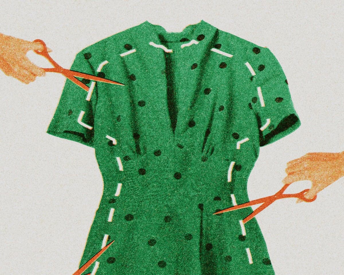Green dress with dashed cut lines and scissors cutting around the silhouette.